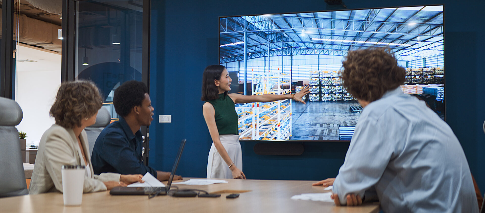 Group of gen z multiethnic businesspeople team meeting discussion in corporate office meeting room, presentation on TV screen. Workplace diversity, work life, team building, business people lifestyle